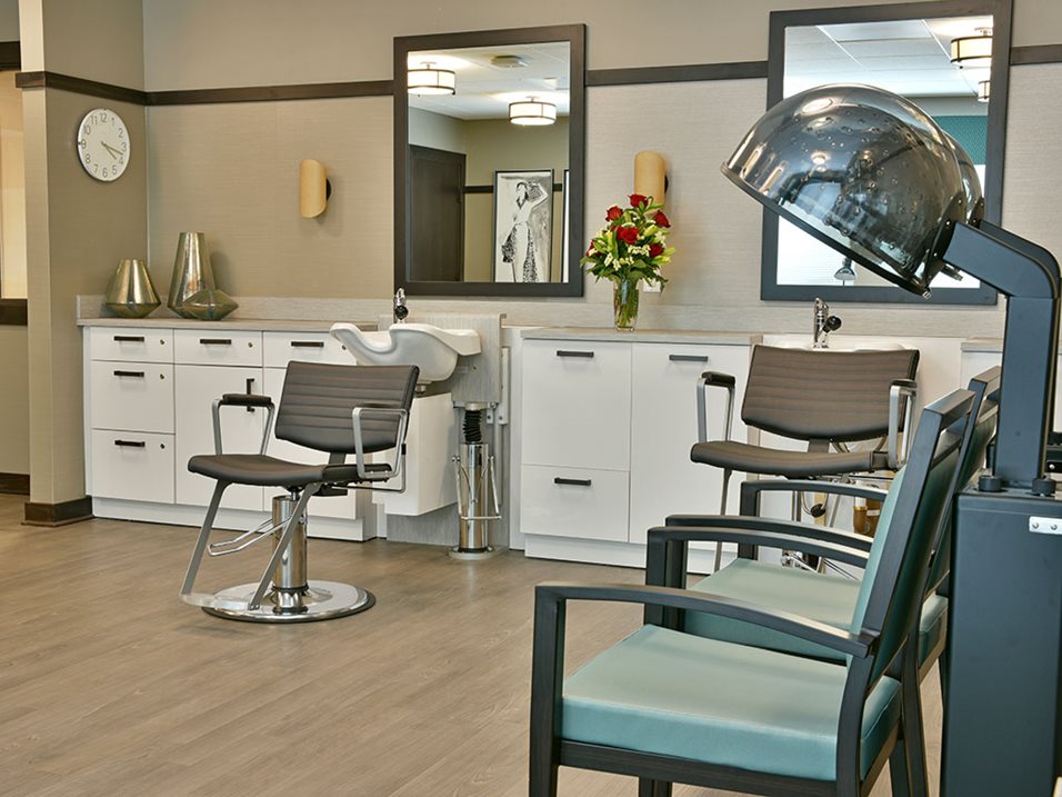 Modern hair salon with chairs, a washing sink, and a hair dryer