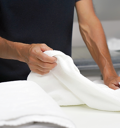 man folding towels
