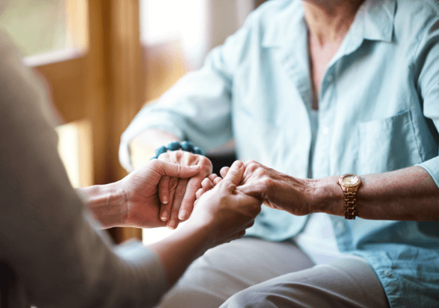Rose Senior Living Carmel holding the hands of a senior woman